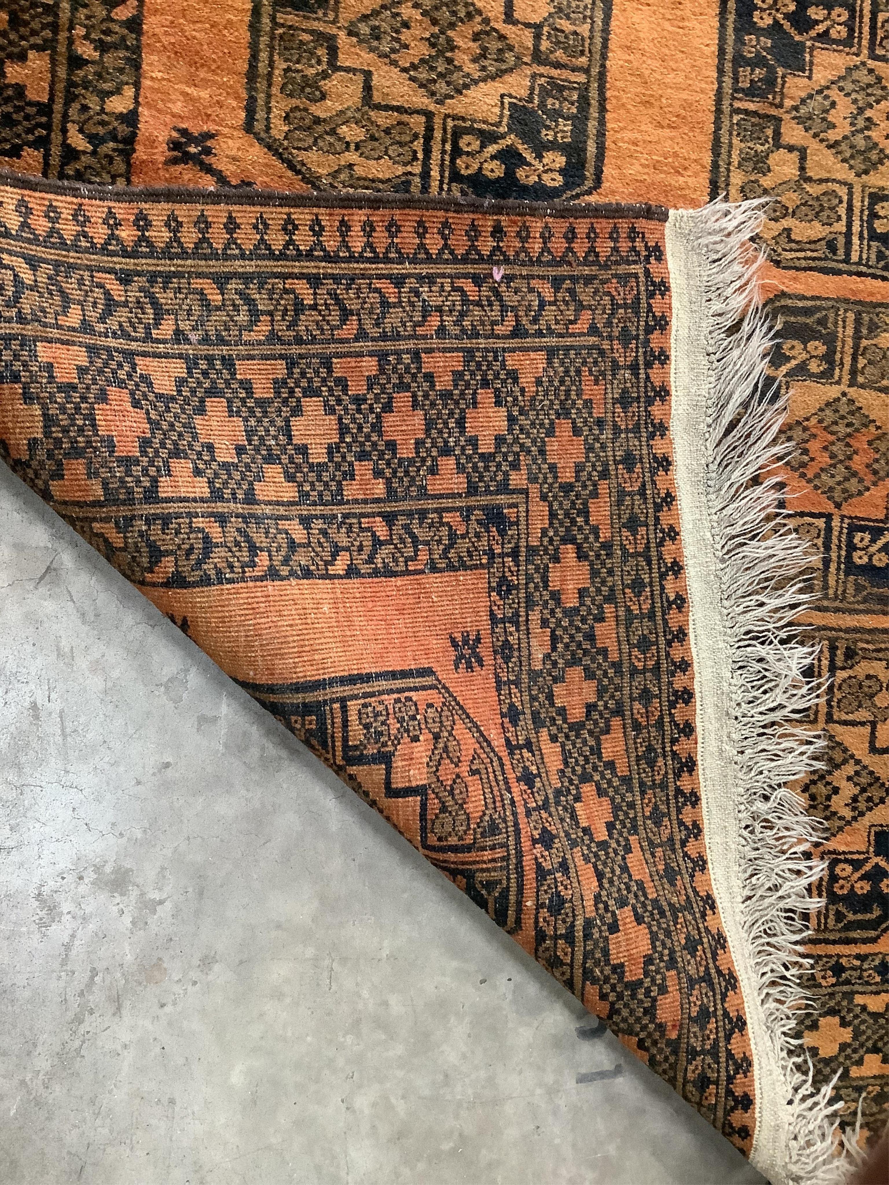 An Afghan gold ground rug, 200 x 154cm. Condition - fair